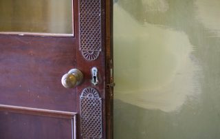 part of brown door with knob
